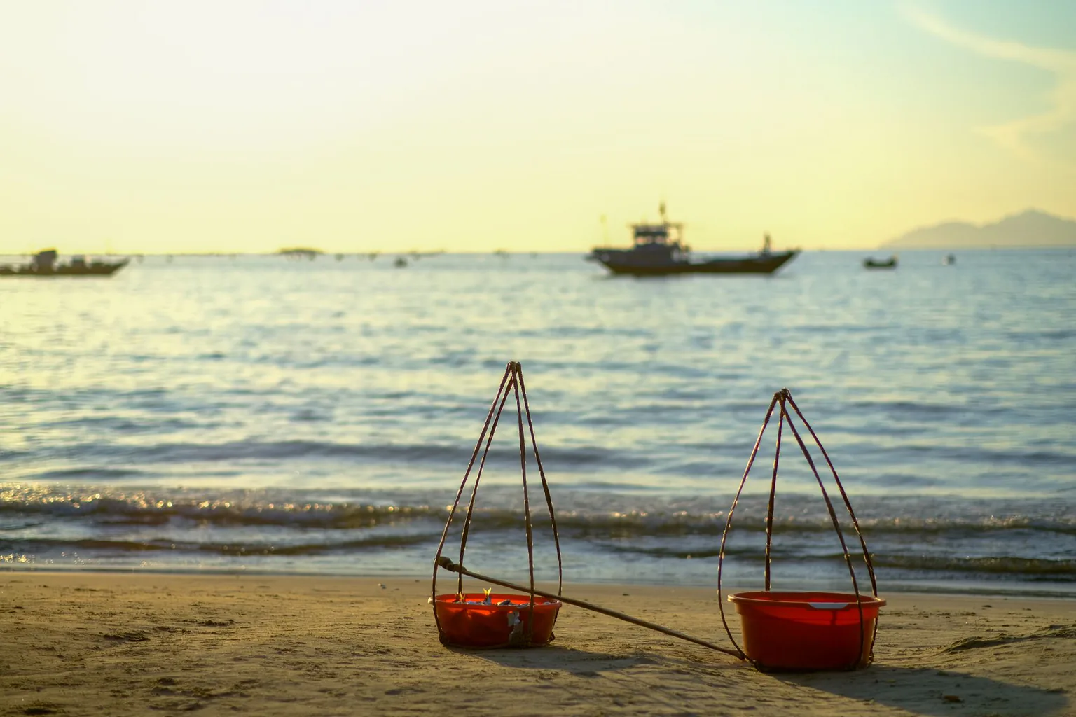 Hoi An beach at sunrise with fishing boats