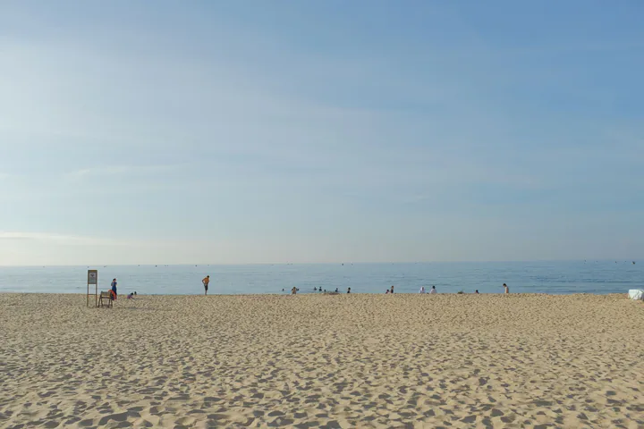 Fine golden sand and clear blue water at My Khe Beach in Da Nang