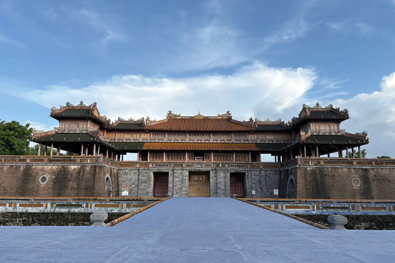 A multi-tiered tiled gatehouse in imperial-style architecture under a blue sky