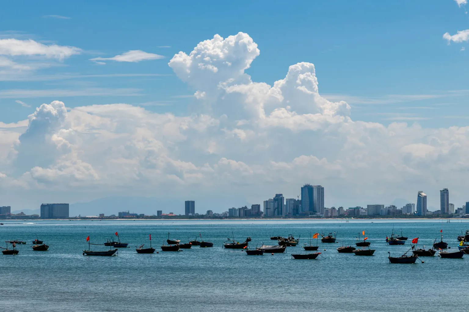 Da Nang bay with fishing boats moored under clear skies