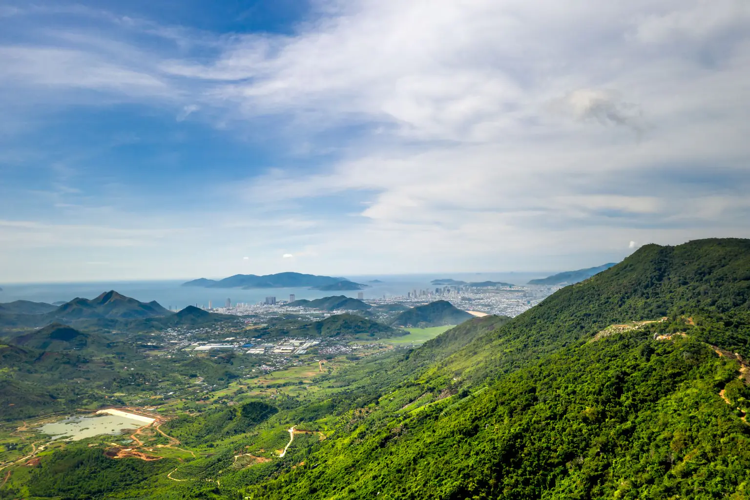 Green hills looking toward a city