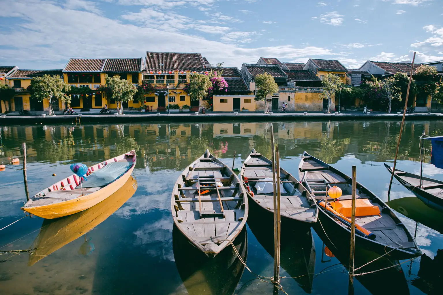 Wooden boats and old-town riverfront on the Hoai River in Hoi An