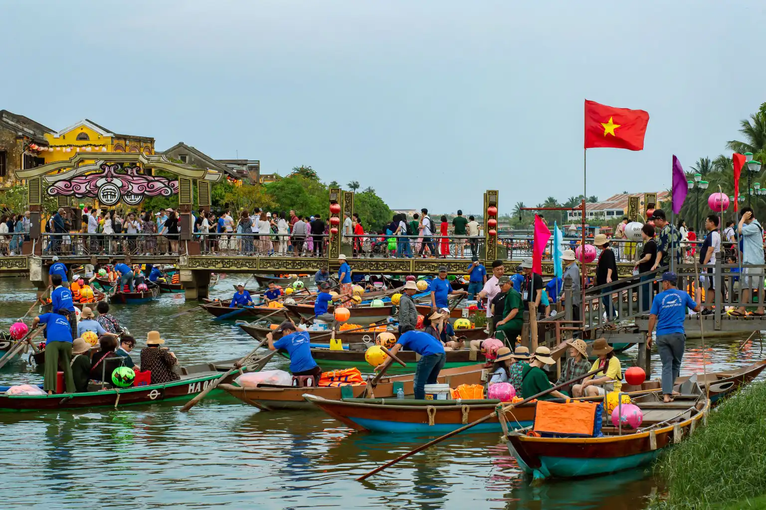 Boats and visitors on the river in Hoi An