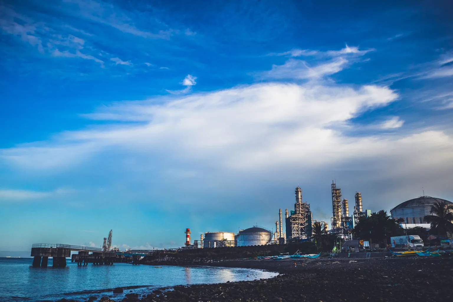 Coastal industrial zone under a cloudy sky