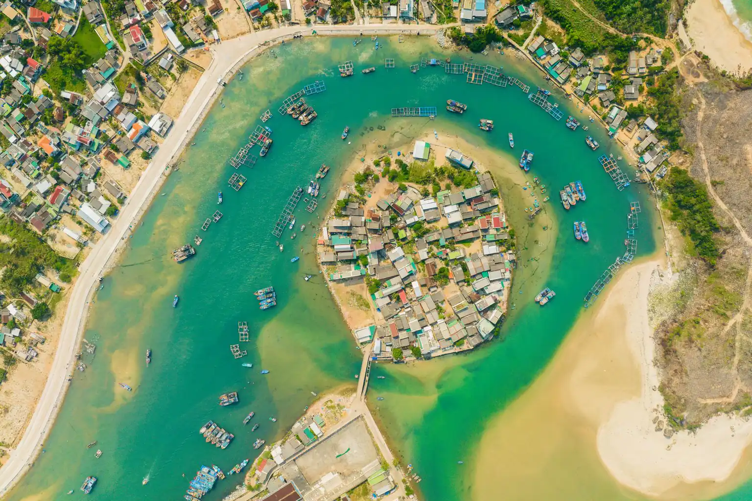 Aerial view of boats anchored beside an island
