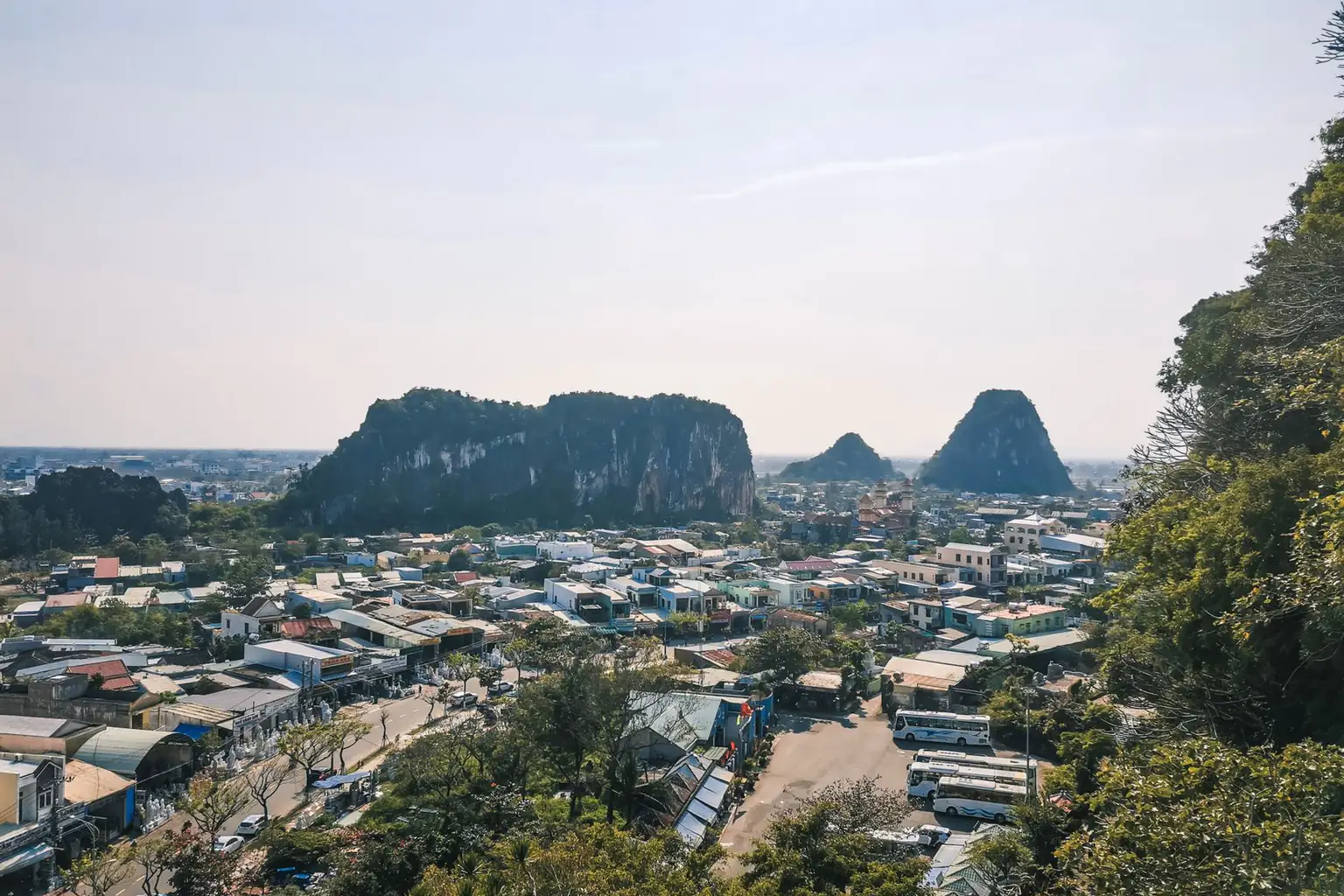 An overview of the Marble Mountains limestone hills rising from a coastal city
