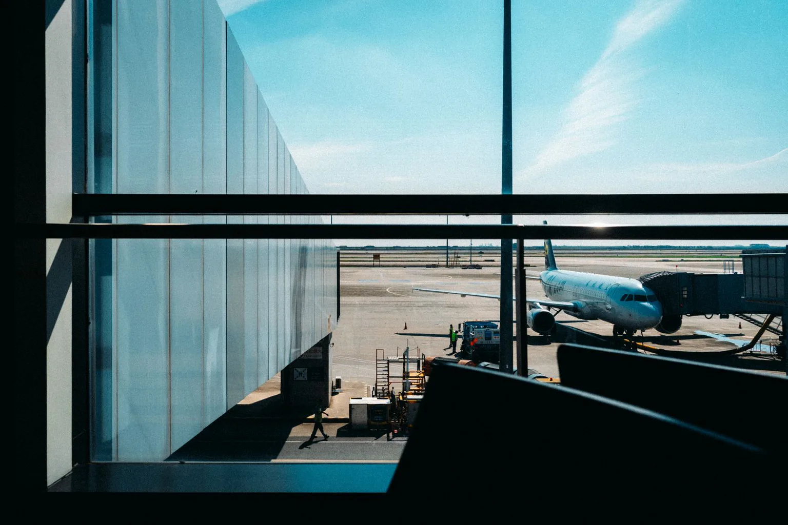 Aircraft parked at a jet bridge at an airport terminal